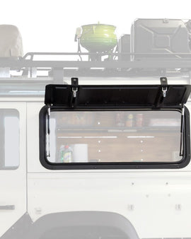 ​​​The Front Runner Gullwing window replaces the rear windows of a Defender and allows for easy access to the load area of your vehicle, through the Gullwing.